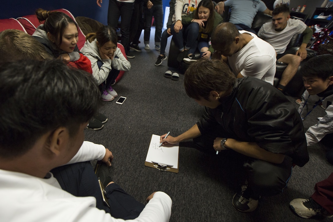 MCAS FUTENMA, OKINAWA, Japan— Nozomu Miyagi draws during a game of Pictionary Dec. 17 in the Single Marine Program building on Marine Corps Air Station Futenma, Okinawa, Japan.