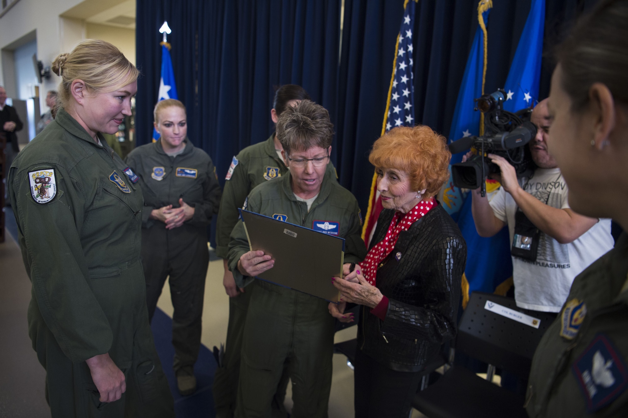 Ms. Elinor Otto autographs pictures for the members of March Air Reserve Base.