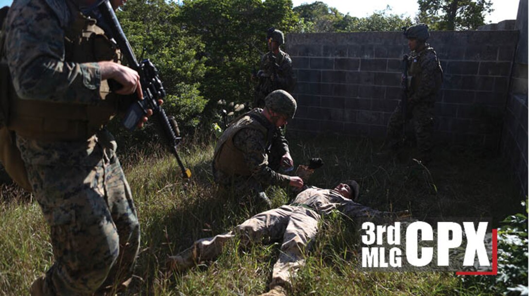 Marines with 3rd Marine Logistics Group Headquarters search a notional hostage during a command post exercise at Combat Town, Marine Corps Base Camp Butler, Okinawa, Japan, Dec. 12, 2017. The CPX was a four-day field exercise designed to test the limits of 3rd MLG in its abilities to command and control logistics units from a jump combat operations center. (U.S. Marine Corps photo by Cpl. Breanna L. Weisenberger)