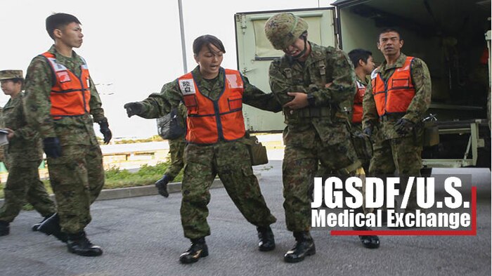 Japan Ground Self Defense Force soldiers with Medical Department, Ground Staff Office, Western Army, attend to a simulated casualty during a mass-casualty scenario Dec. 12, 2017, at Camp Naha, Okinawa, Japan. Medical personnel from 3rd Medical Battalion, 3rd Marine Logistics Group; U.S. Naval Hospital Okinawa; and 18th Medical Group, 18th Wing Support Squadron were invited to Camp Naha during the Japanese and U.S. Medical Expert Exchange Event training to learn more about each service’s medical training, tactics and procedures. (U.S. Marine Corps photo by Sgt. Tiffany Edwards)
