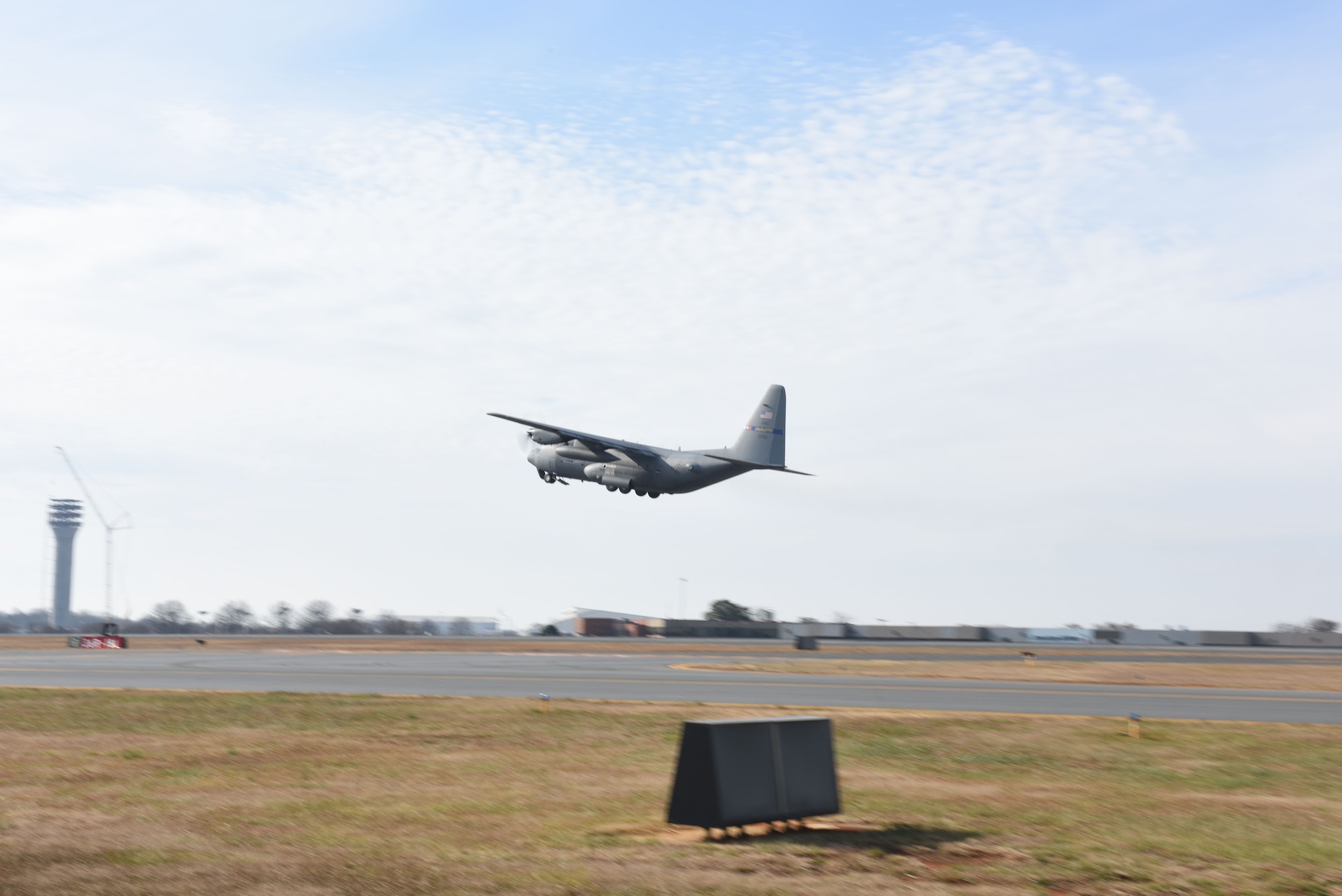 The last C-130 Hercules aircraft attached to the North Carolina Air National Guard Base, Charlotte Douglas International Airport departs for a new assignment at the 165th Airlift Wing in Savannah, Georgia, Dec. 18, 2017. The NCANG is in transition from flying the C-130 Hercules to C-17 Globemaster III aircraft. The change in mission will require not only a transition in aircraft and personnel, but an increase in structures throughout the base.