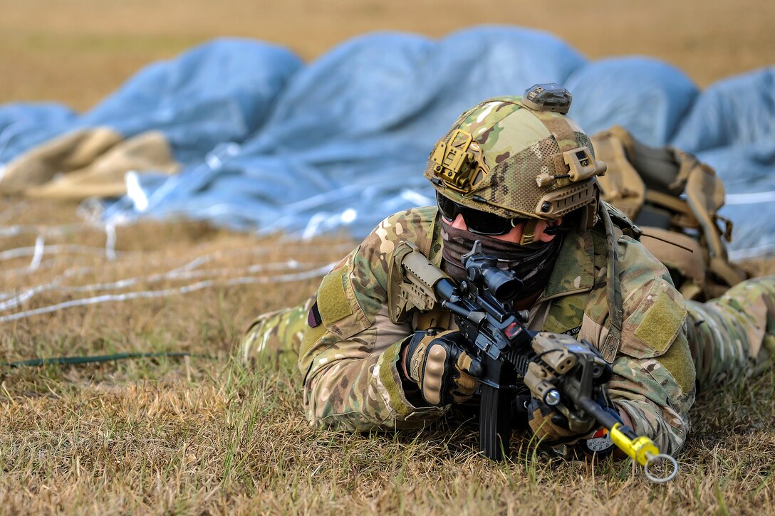 An Air Force pararescueman provides security after conducting airborne insertion training.