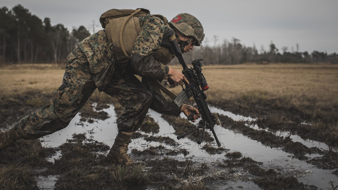 A U.S. Marine assigned to Delta Company, Infantry Training Battalion, School of Infantry-East, rushes towards an objective during a combined arms exercise at Camp Lejeune, N.C., Dec. 15, 2017. The combined arms exercise allowed riflemen and machine gunners to work together by closing with and destroying targets by fire and maneuver.
