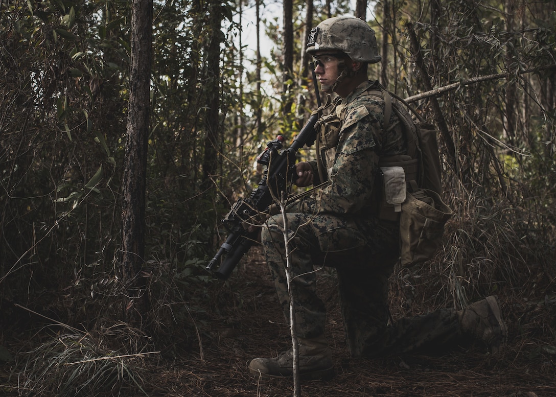 A U.S. Marine assigned to Delta Company, Infantry Training Battalion, School of Infantry-East, prepares to assault an objective during a combined arms exercise at Camp Lejeune, N.C., Dec. 15, 2017. The combined arms exercise allowed riflemen and machine gunners to work together by closing with and destroying targets by fire and maneuver.