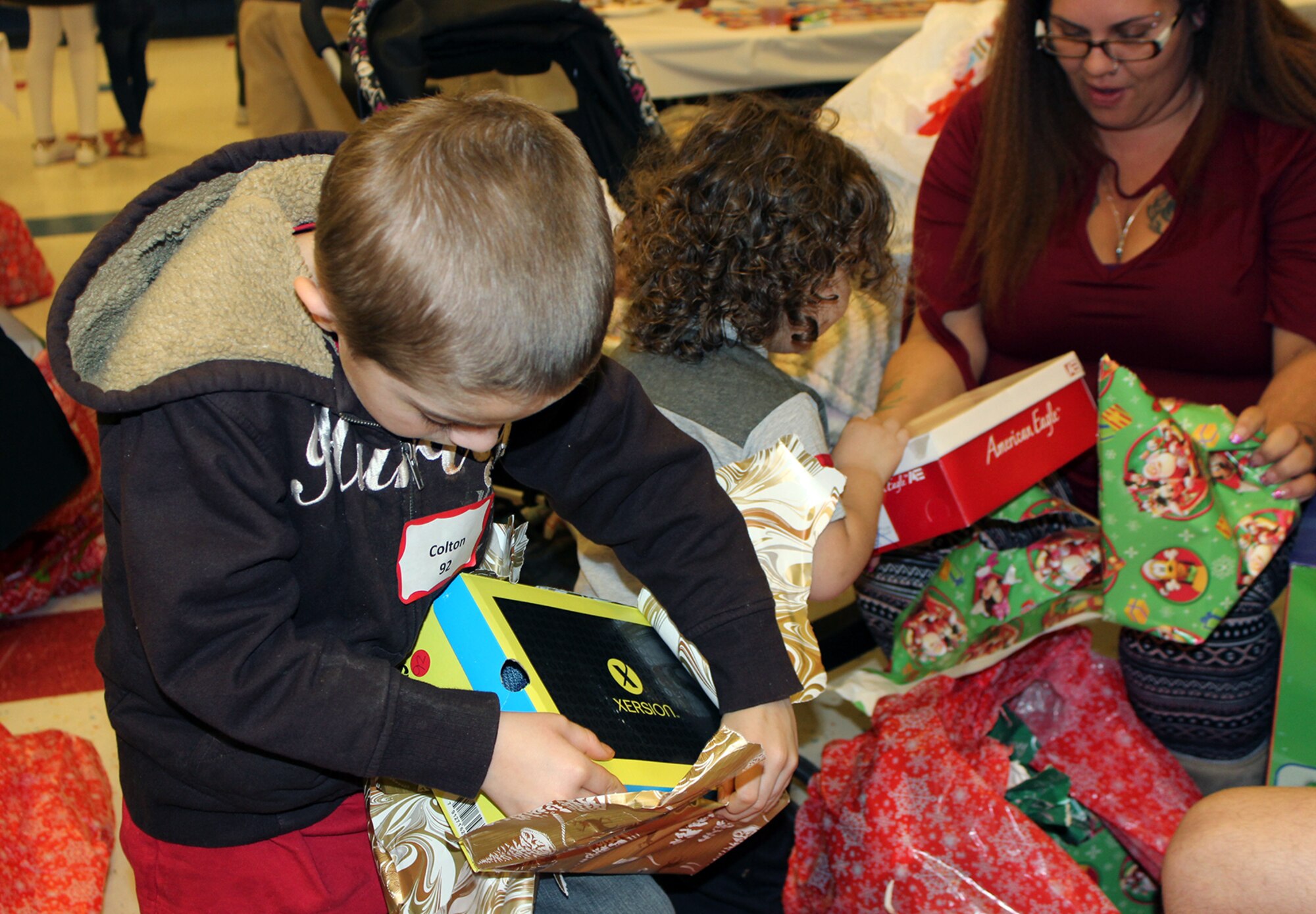 Air Force Civil Engineeer Center volunteers distributed gifts to 165 children at the “Spread the Joy” gift-giving party and dinner held at Lucille Moore Elementary School in Panama City on December 15. Each child received a coat, shirt, pants, a pair of shoes and two toys of their choice. Santa stopped by to with everyone a Merry Christmas.