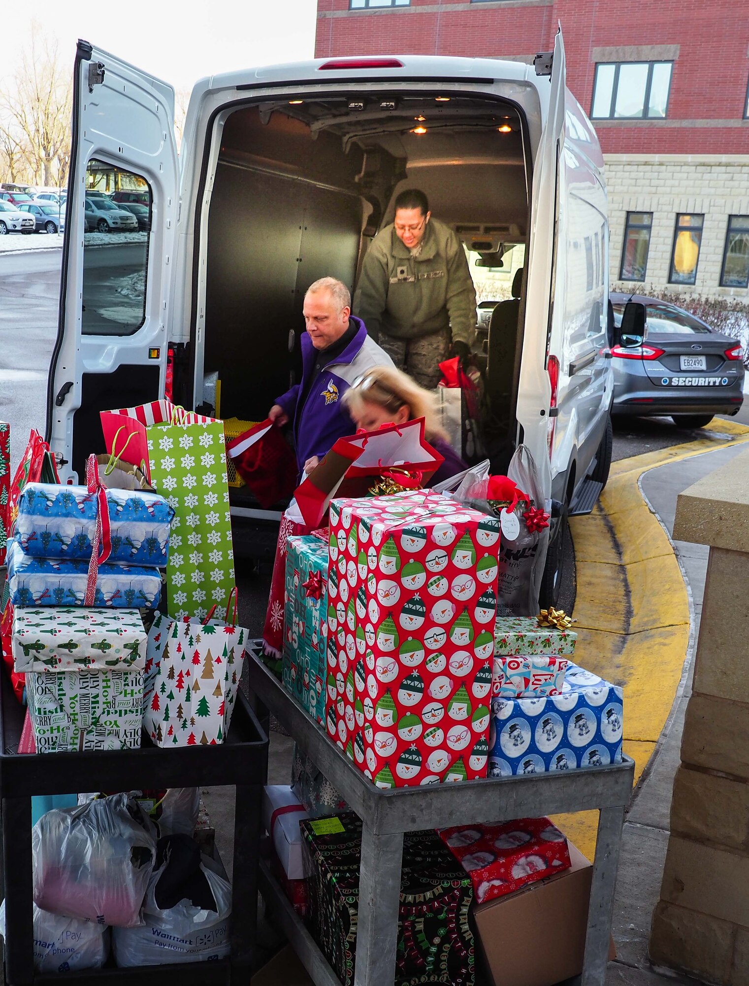 Rick Pelzl and Lt. Col. Karen Rowe, 934th Force Support Squadron, unload a truck full of gifts to the Minnesota Veteran's Home Dec. 19. (Air Force Photo/Paul Zadach)