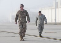 Col. Les Bradfield, 919th Special Operations Wing commander, searches for debris on the tarmac