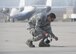 Tech. Sgt. Ken Frederick, 919th Special Operations Aircraft Maintenance Squadron, stops to remove a piece of debris from the tarmac at Duke Field