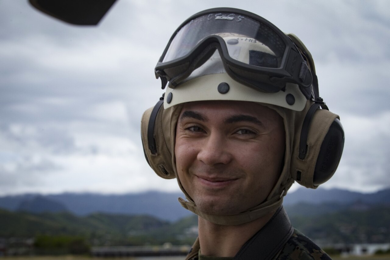 Marine Corps Sgt. Aaron Patterson, a combat photographer with Headquarters Battalion, Marine Corps Base Hawaii, awaits the arrival of AH-1Z helicopters at Marine Corps Air Station, Kaneohe Bay, Hawaii, Dec. 19, 2017. The arrival of the 4th generation attack helicopters enhances the capabilities and power projection of Marine Light Attack Helicopter Squadron 367, Marine Aircraft Group 24, 1st Marine Aircraft Wing and Marine Corps Base Hawaii. Marine Corps photo by Sgt. Alex Kouns