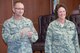 Chief Master Sgts. Marion Lollis Jr., 919th Special Operations Aircraft Maintenance Squadron,  and Jennifer Neal, 919th Special Operations Maintenance Group react to applause