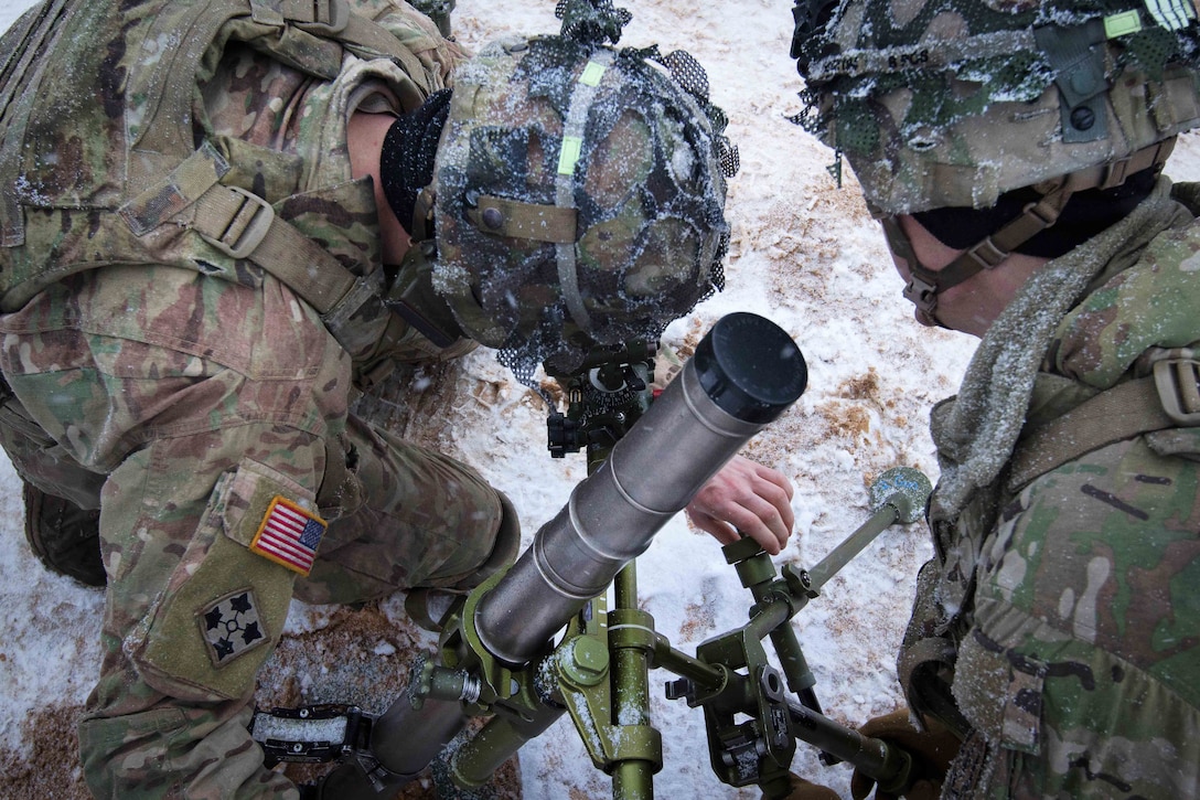 Soldiers sight in and adjust their team’s 60-millimeter mortar.