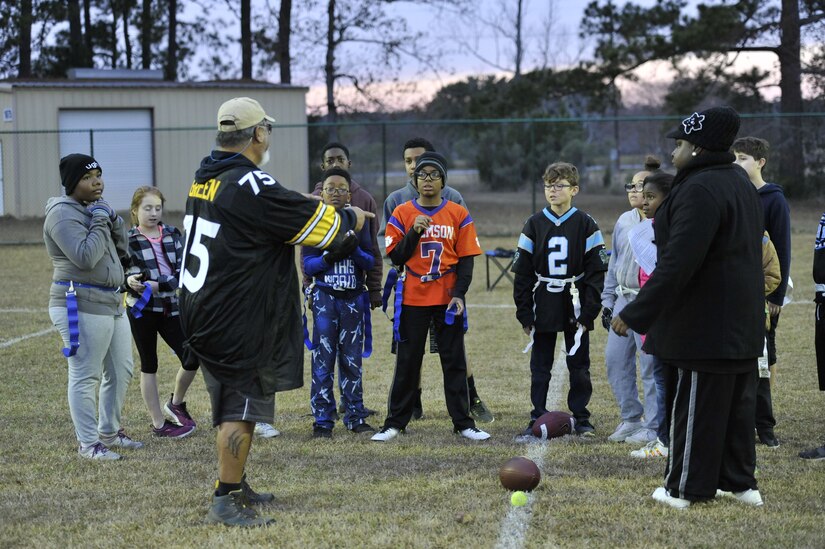 Children with the Weapons Station youth center receive a final pep talk before beginning a flag football game Dec. 14, 2017, at Joint Base Charleston – Weapons Station, S.C.
