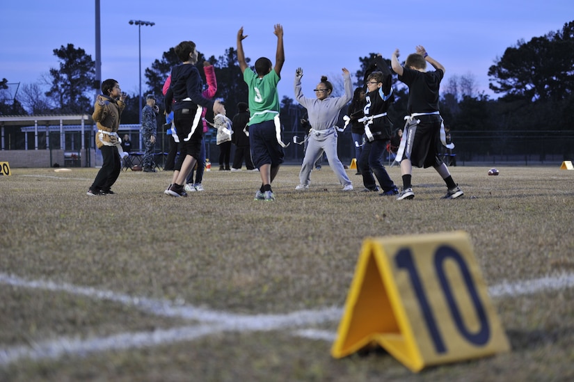 Children with the Weapons Station youth center warm-up for a flag football game Dec. 14, 2017, at Joint Base Charleston – Weapons Station, S.C.