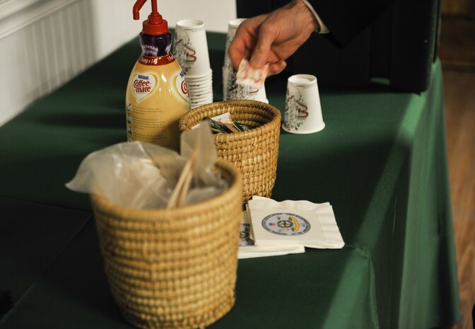 An attendee of the Federal Executive Association holiday coffee drop-in prepares coffee Dec. 15, 2017, at Coast Guard Sector Charleston’s Brass Buckle conference room.