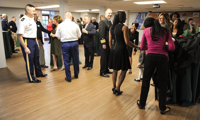 Attendees of the Federal Executive Association holiday coffee drop-in chat over coffee and breakfast Dec. 15, 2017, at Coast Guard Sector Charleston’s Brass Buckle conference room.