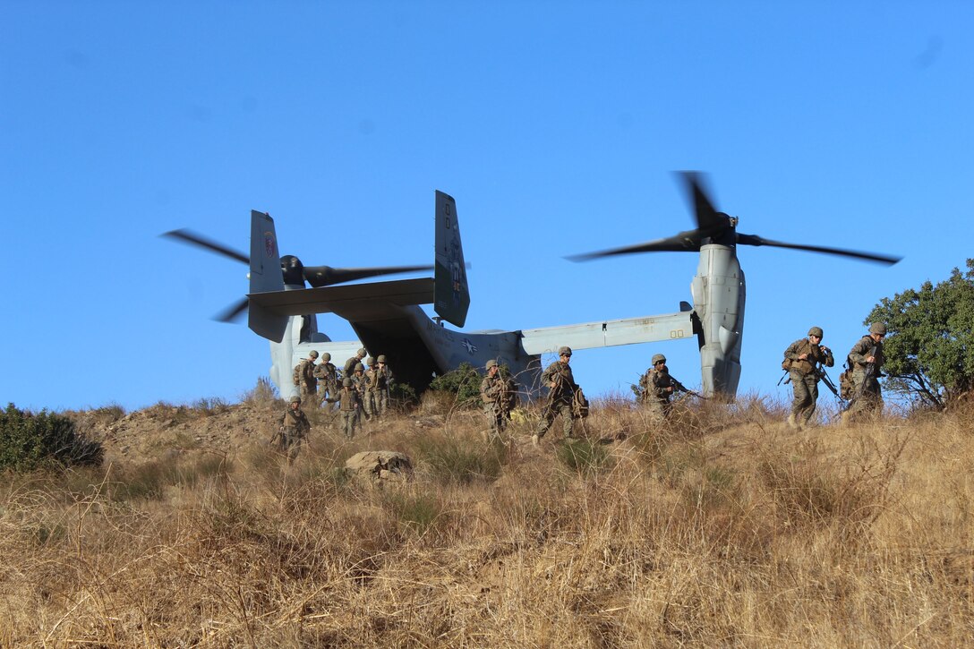 A detachment from 9th Communication Battalion offloads from a MV-22 while conducting a refueling mission as part of the Battalion Field Exercise 1-18.   Beyond communications, Marines trained on land navigation, security, and flight operations during the exercise.