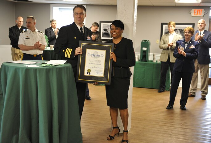 Shanda S. Johnson, Space and Naval Warfare Systems Center outreach director, receives the Order of the Silver Crescent award Dec. 15, 2017, at Coast Guard Sector Charleston’s Brass Buckle conference room.