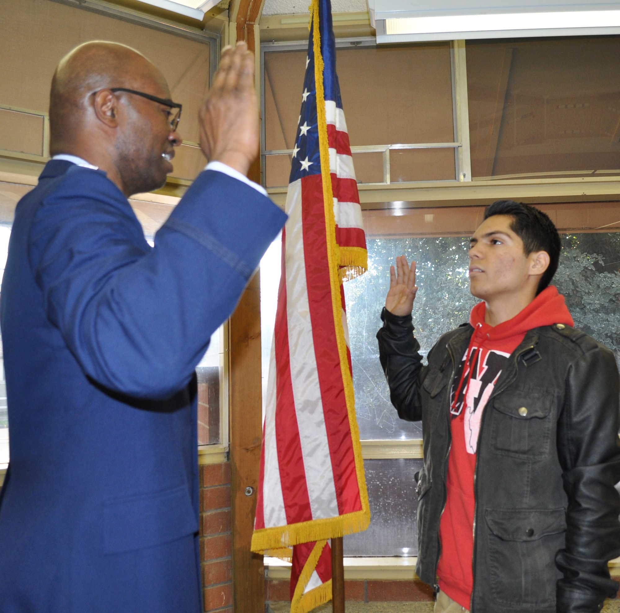 The 349th Air Mobility Wing gained a new reservist, Juan Garcia, from Winters High School Dec. 14. Garcia was sworn in by Chaplain (Capt.) Kemuel Bellows, in front of a number of proud family, including his mother and grandfather. (U.S. Air Force photos / Ellen Hatfield)