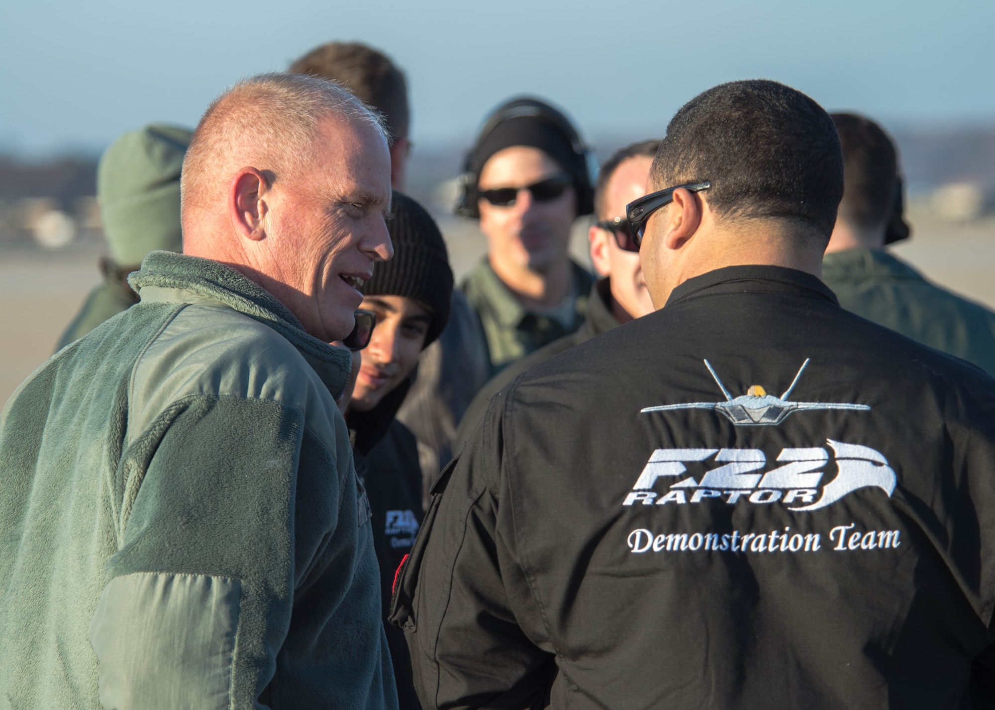 U.S. Air Force Chief Master Sgt. Frank Batten, command chief of Air Combat Command, speaks with the F-22 Raptor Demonstration Team during a performance at Joint Base Langley-Eustis, Va., Dec. 18, 2017.