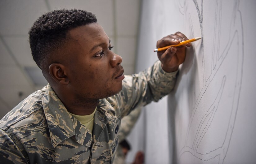 Airman 1st Class Winard Azaglo, 628th Logistics Readiness Squadron vehicle operator, shades in a drawing of a vehicle operator occupational badge at the vehicle operations building on Joint Base Charleston, S.C., Dec. 5, 2017.
