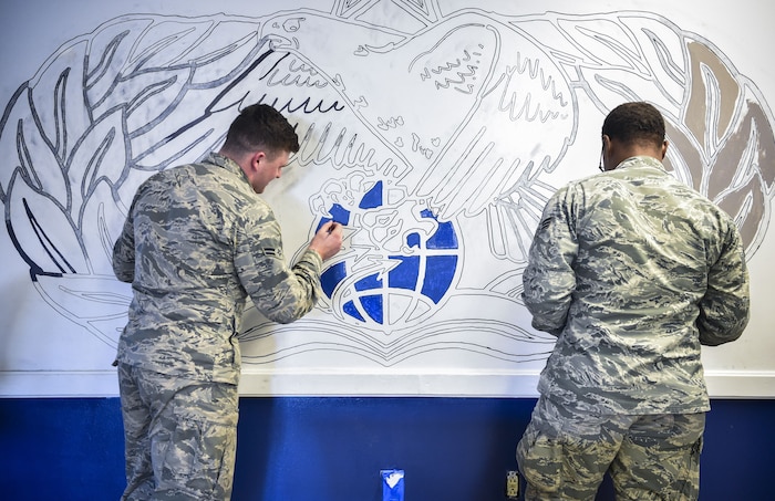 Vehicle operators from the 628th Logistics Readiness Squadron paint an occupational badge at the vehicle operations building on Joint Base Charleston, S.C., Dec. 9, 2017.