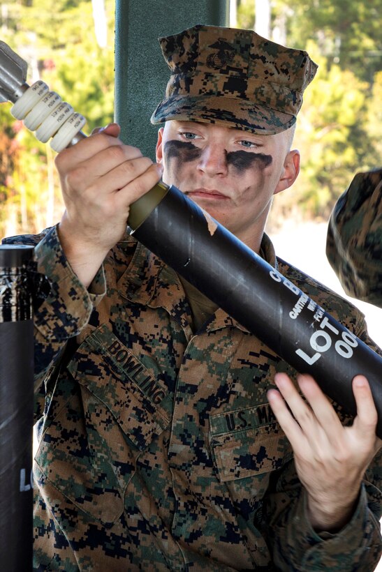 A Marine inspects a mortar round.