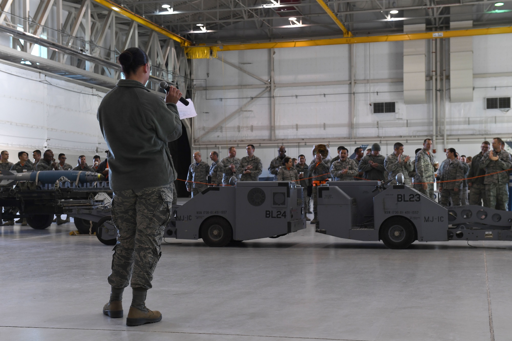 An Airman delivers opening remarks before the 432nd Aircraft Maintenance Squadron’s quarterly weapons load competition Dec. 8, 2017, at Creech Air Force Base, Nev. Creech has held these competitions for its remotely piloted aircraft load crews since 2009 to help boost unit morale and highlight the team’s capabilities. (U.S. Air Force photo by Senior Airman James Thompson)