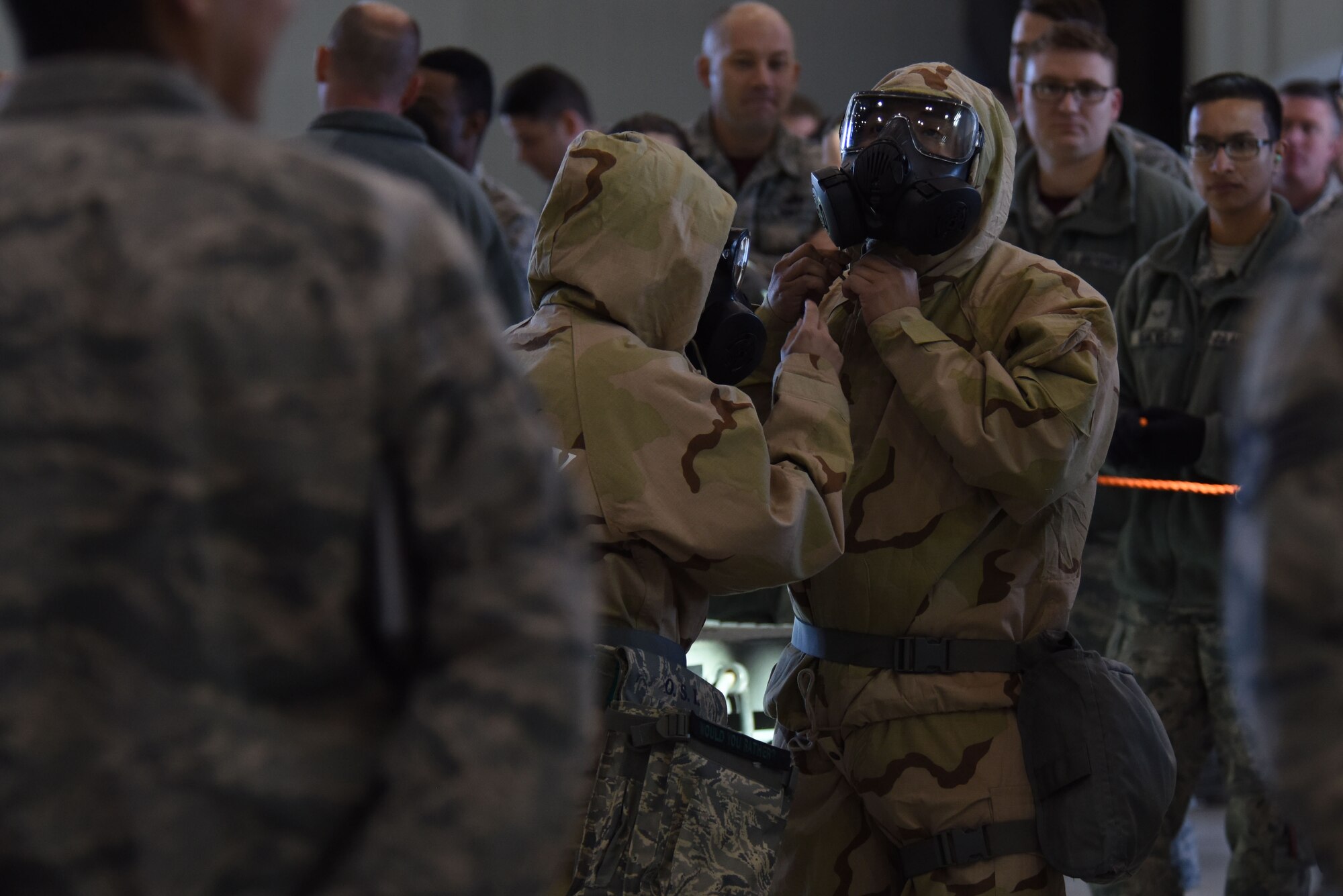 Airmen assigned to the 432nd Aircraft Maintenance Squadron Reaper Aircraft Maintenance Unit perform final chemical gear checks before a weapons load competition Dec. 8, 2017, at Creech Air Force Base, Nev. Maintenance Airmen pride themselves on staying mission ready and hosted their first weapons load competition dressed in full chemical, biological, radiological, nuclear and explosives gear in more than three years. (U.S. Air Force photo by Airman 1st Class Haley Stevens)