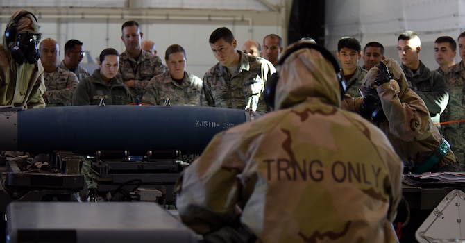 Airmen assigned to the 432nd Aircraft Maintenance Squadron Reaper Aircraft Maintenance Unit coordinate to load a GBU-38 Joint Direct Attack Munition during a weapons load competition Dec. 8, 2017, at Creech Air Force Base, Nev. Weapons load competitions help build camaraderie and highlight the load crew’s capabilities to load munitions safely. (U.S. Air Force photo by Airman 1st Class Haley Stevens)