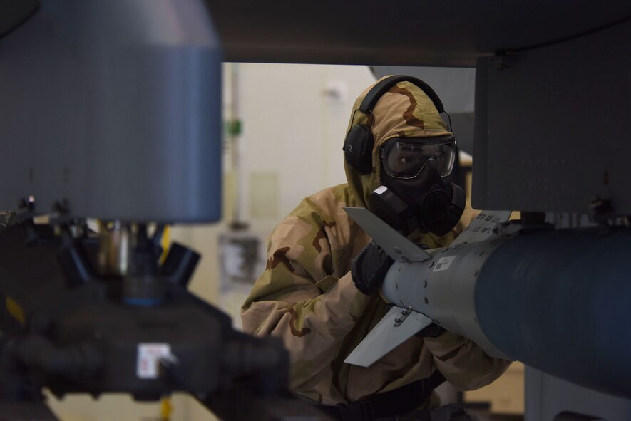 An Airman assigned to the 432nd Aircraft Maintenance Squadron Reaper Aircraft Maintenance Unit loads a GBU-38 Joint Direct Attack Munition during a weapons load competition Dec. 8, 2017, at Creech Air Force Base, Nev. Weapons load competitions are composed of a written test, tool kit evaluation, and a weapons load where safety procedures and time are closely monitored. (U.S. Air Force photo by Airman 1st Class Haley Stevens)