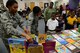 Capt. Alisha Foster, 14th Flying Training Wing Equal Opportunity Director, and Capt. Tara Dixon, 14th FTW Chaplain, help children pick out a book Dec. 20, 2017, at West Lowndes Elementary School in Columbus, Mississippi. Every child got to select a book and the left over books were donated to the school’s library. (U.S. Air Force photo by Airman 1st Class Beaux Hebert)