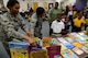 Capt. Alisha Foster, 14th Flying Training Wing Equal Opportunity Director, and Capt. Tara Dixon, 14th FTW Chaplain, help children pick out a book Dec. 20, 2017, at West Lowndes Elementary School in Columbus, Mississippi. Every child got to select a book and the left over books were donated to the school’s library. (U.S. Air Force photo by Airman 1st Class Beaux Hebert)