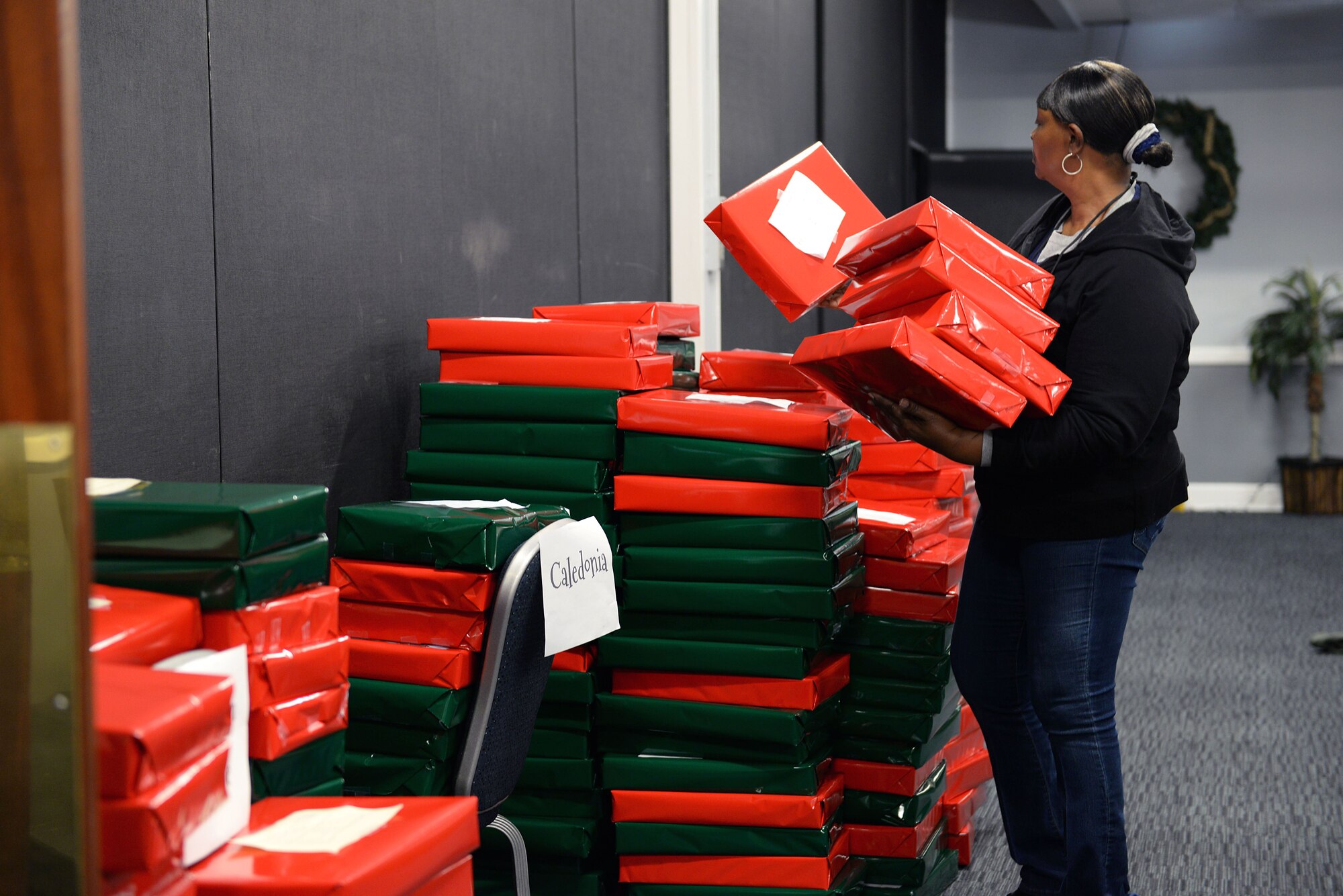 Chan Johnson, 14th Logistics and Readiness Squadron Material Handler, organizes presents Dec. 14, 2017, on Columbus Air Force Base, Mississippi, during the Happy Fund Shop and Wrap. The presents were sent to children chosen by their teachers at eight local schools. (U.S. Air Force photo by Airman 1st Class Keith Holcomb)