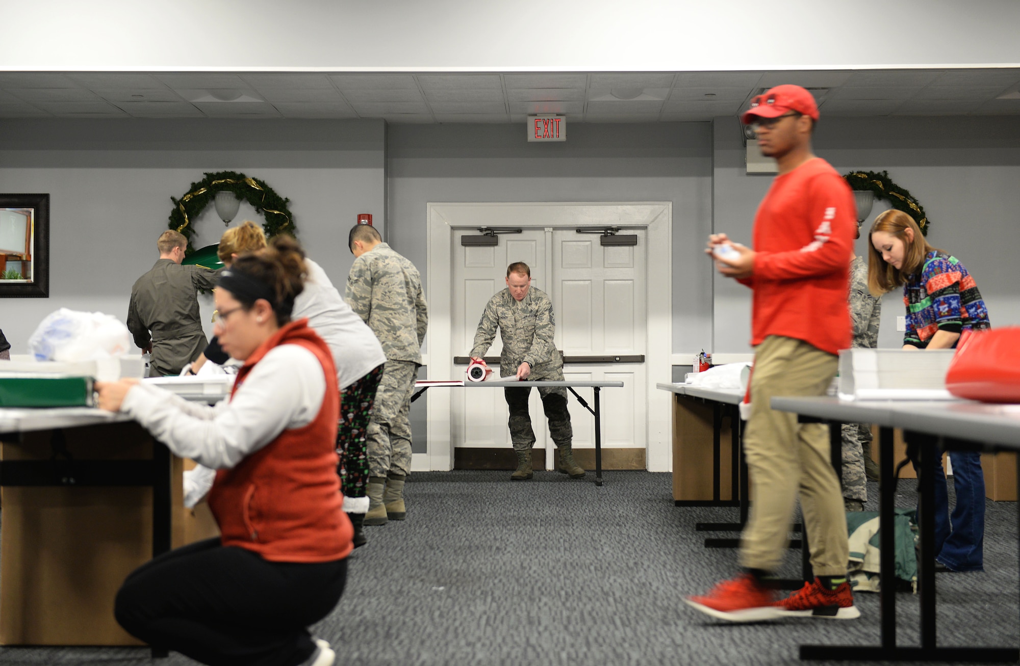 Team BLAZE members pack and wrap gifts for the Happy Fund Shop and Wrap event Dec. 14, 2017, on Columbus Air Force Base, Mississippi. George "Happy" Irby started the Happy Fund Shop and Wrap in 1958 with tip money he earned working in the Columbus Club. (U.S. Air Force photo by Airman 1st Class Keith Holcomb)