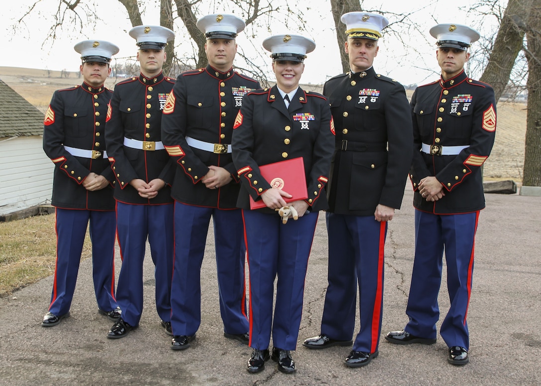 Sergeant Sara McGaffee, a Sioux Falls, S.D., native, poses for a photo with the Marines of Recruiting Sub Station Sioux Falls after being awarded the Purple Heart Medal. On Oct. 20th, 2010, while deployed with Combat Logistics Battalion 3, McGaffee’s vehicle was hit by an improvised explosive device while conducting convoy operations in support of Operation Steel Dawn II in the Helmand province of Afghanistan. McGaffee was awarded her Purple Heart, Dec. 16, 2017 in Sioux Falls, S.D., in front of a detail of Marines and her local friends and family.