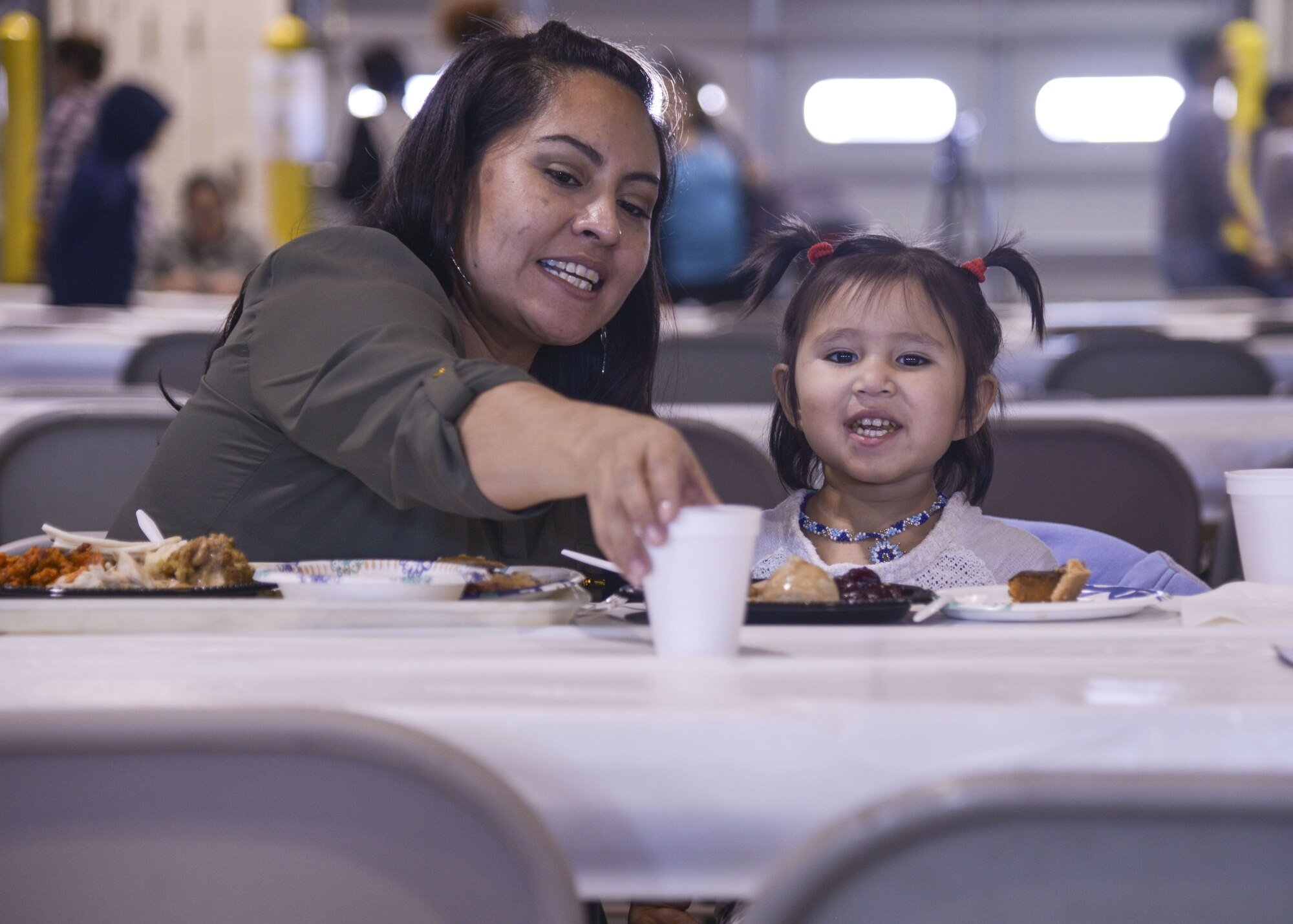 Members of the community surrounding Kirtland enjoy a full holiday meal at the annual Operation Holiday Cheer event on Dec. 20 at Kirtland Air Force Base, New Mexico. This event is hosted by the Kirtland Fire Department for underprivileged families. Children get to visit with Santa leave with a gift.