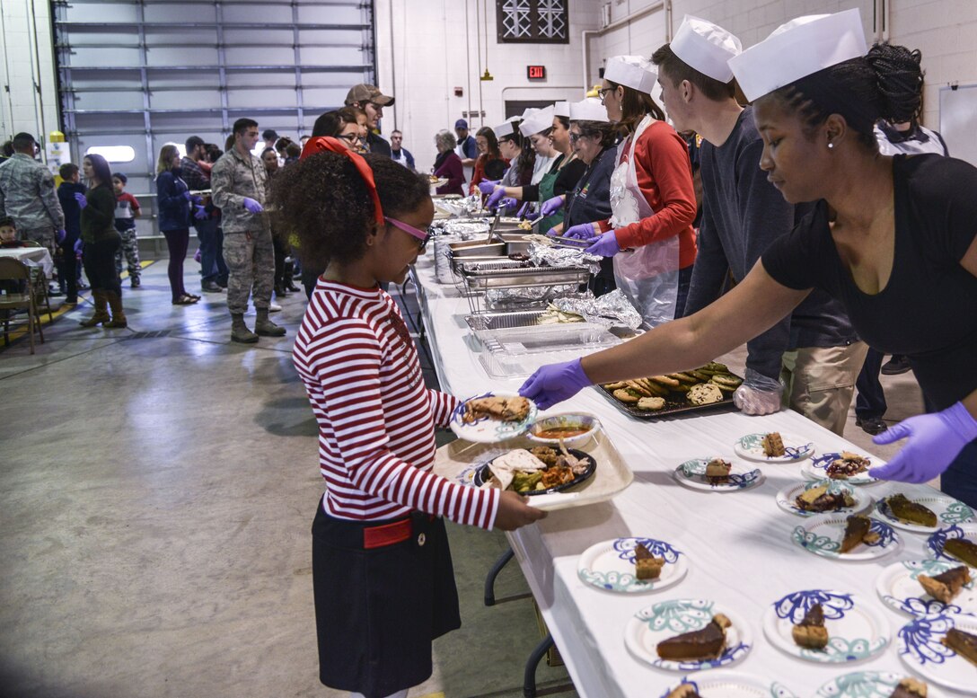 Members of the community are served a full holiday meal at the annual Operation Holiday Cheer event on Dec. 20 at Kirtland Air Force Base, New Mexico. This event is hosted by the Kirtland Fire Department for underprivileged families. Children get to visit with Santa leave with a gift.