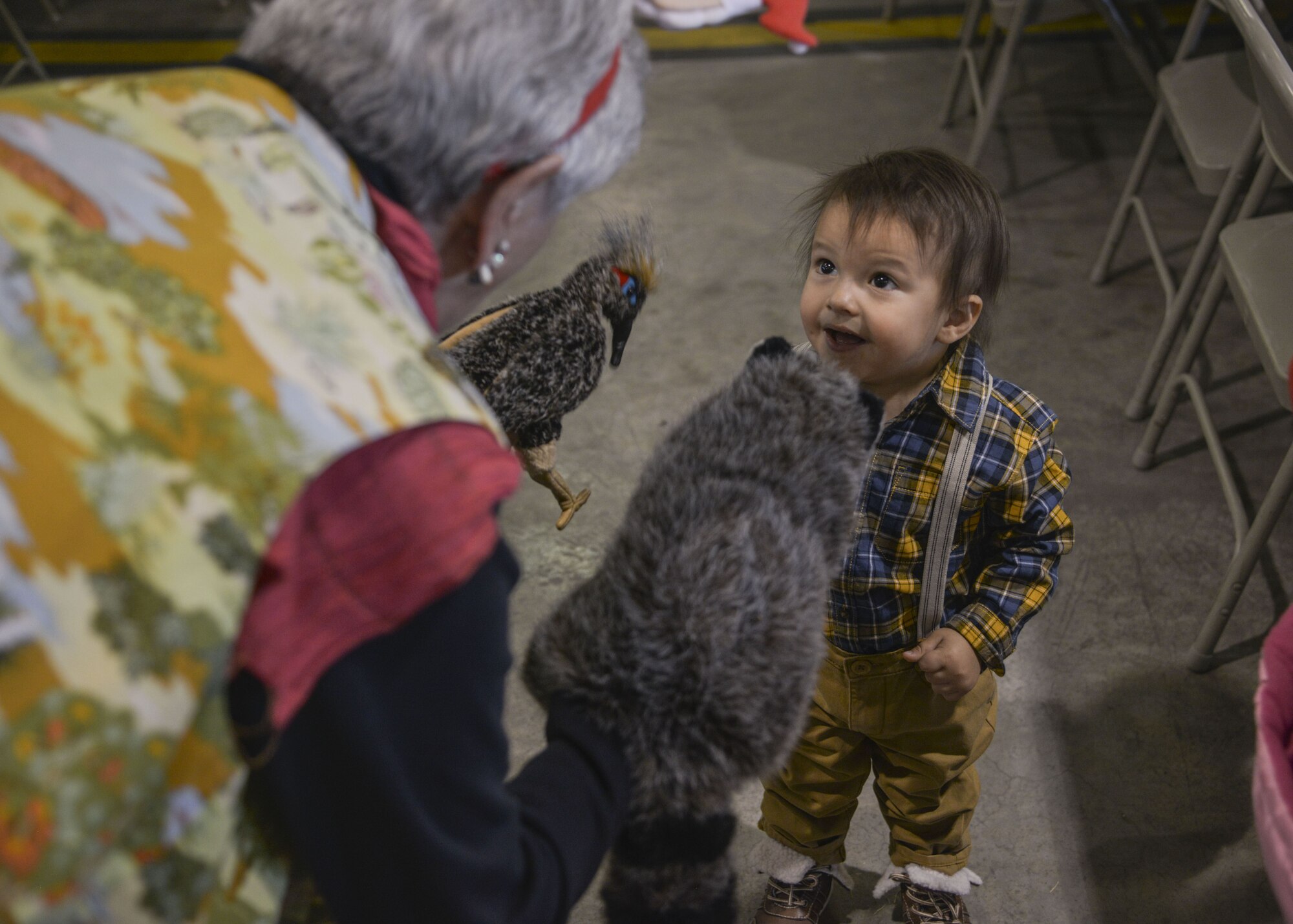 A child admires the animals at the Operation Holiday Cheer on Dec. 20 at Kirtland Air Force Base, New Mexico. This event is hosted by the Kirtland Fire Department and serves underprivileged families in the local communities by giving them a full holiday meal and a visit with Santa, who sends them home with a gift.