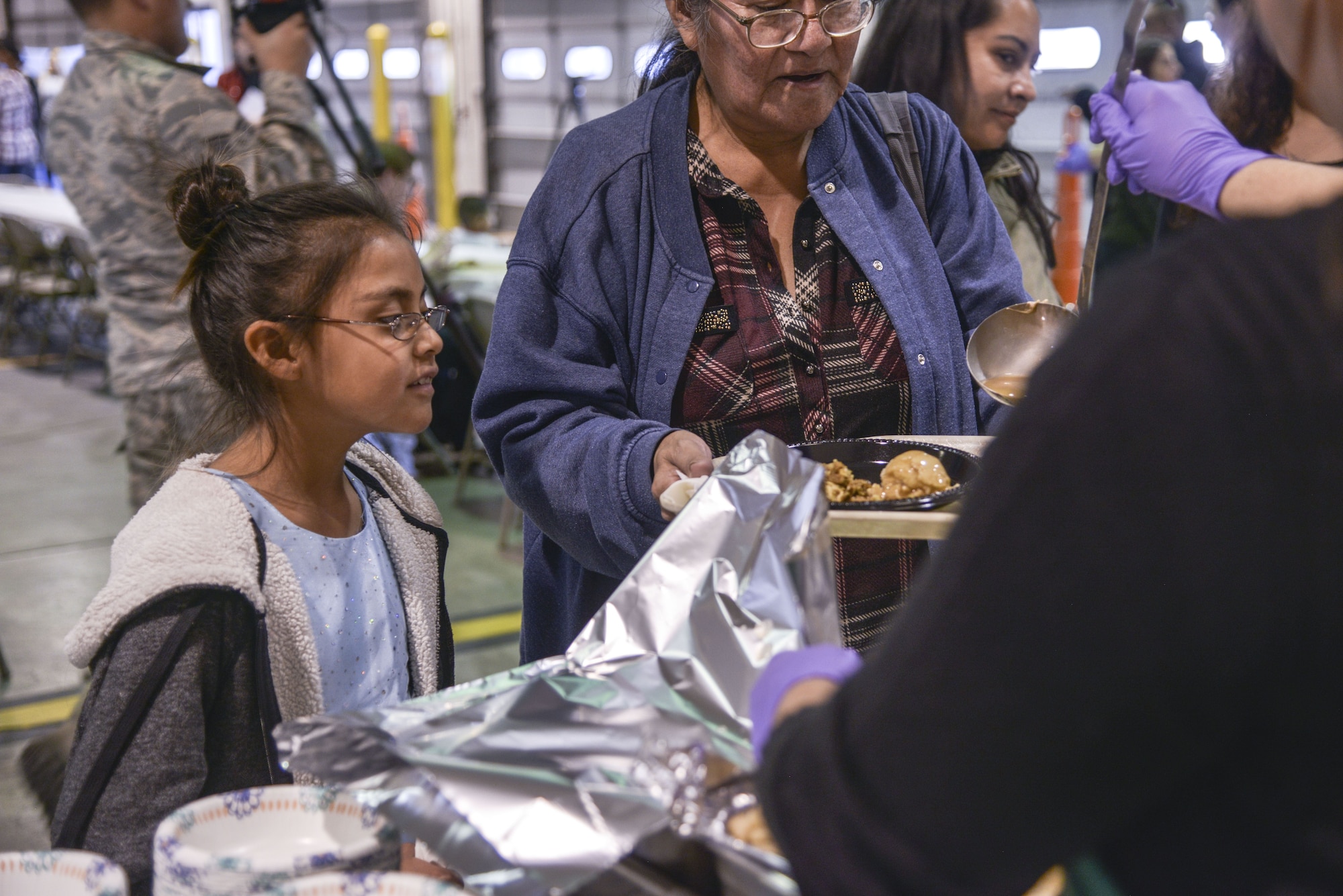 Members of the community surrounding Kirtland are served a full holiday meal at the annual Operation Holiday Cheer event on Dec. 20 at Kirtland Air Force Base, New Mexico. This event is hosted by the Kirtland Fire Department for underprivileged families. Children get to visit with Santa leave with a gift.