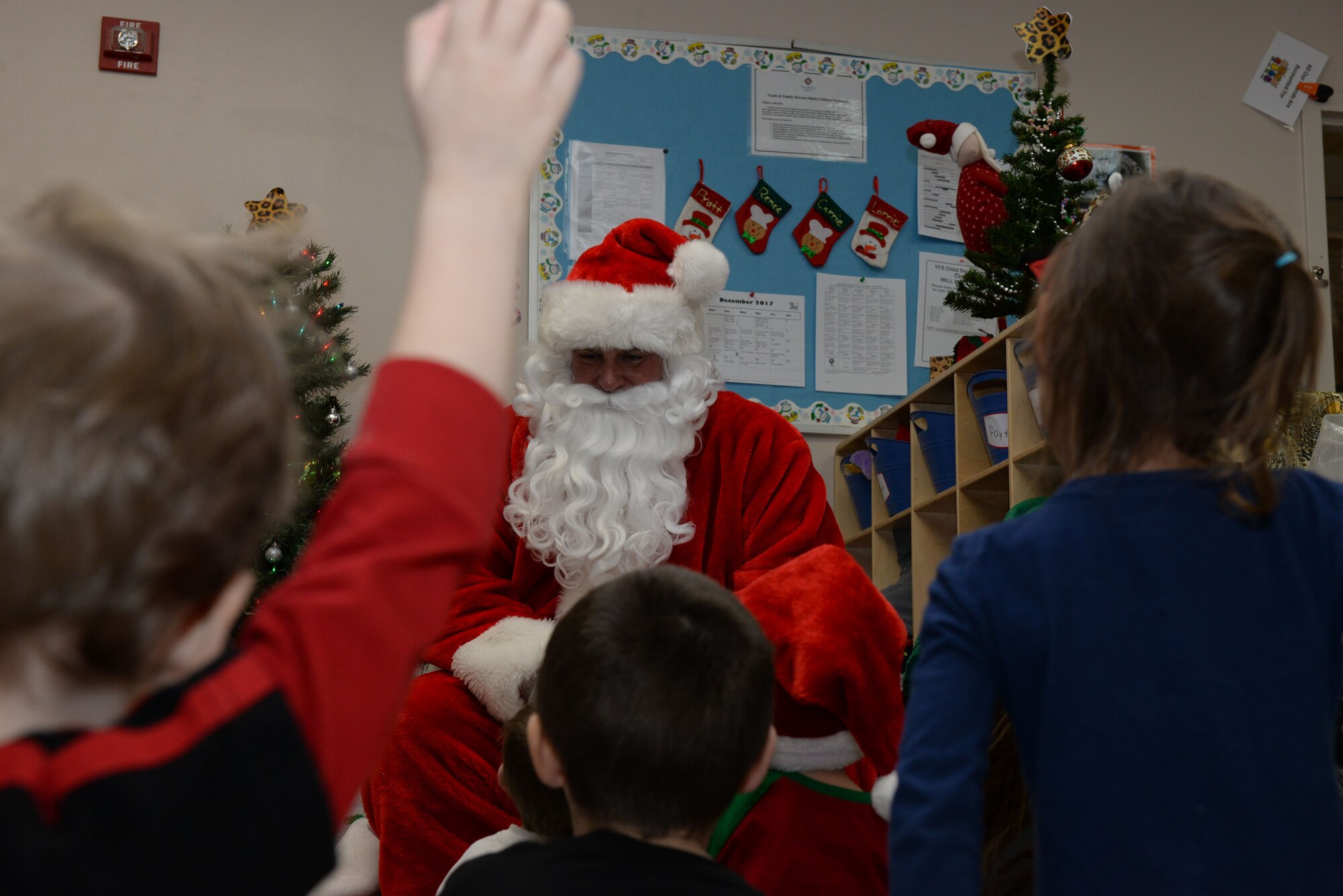Children ask Santa questions inside the Youth & Family Services Child Development Center, in Rapid City, S.D., Dec. 19, 2017. Coordination between the YFS and 28th Operations Group began months in advance to ensure a smooth day of delivering presents and Christmas cheer to children and their families. (U.S. Air Force photo by Airman 1st Class Nicolas Z. Erwin)