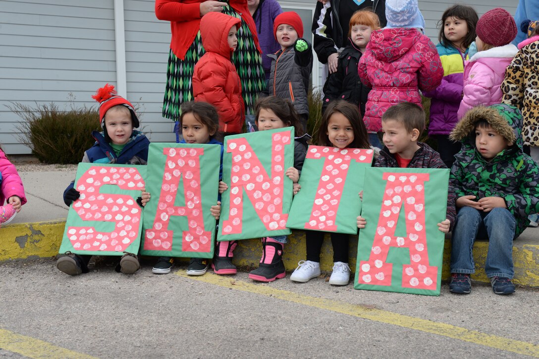 Children and families eagerly wait for Santa to arrive at the Youth & Family Services Child Development Center in Rapid City, S.D., Dec. 19, 2017.  The 28th Operations Group collected and delivered 175 gifts for the annual toy drive. (U.S. Air Force photo by Airman 1st Class Nicolas Z. Erwin)