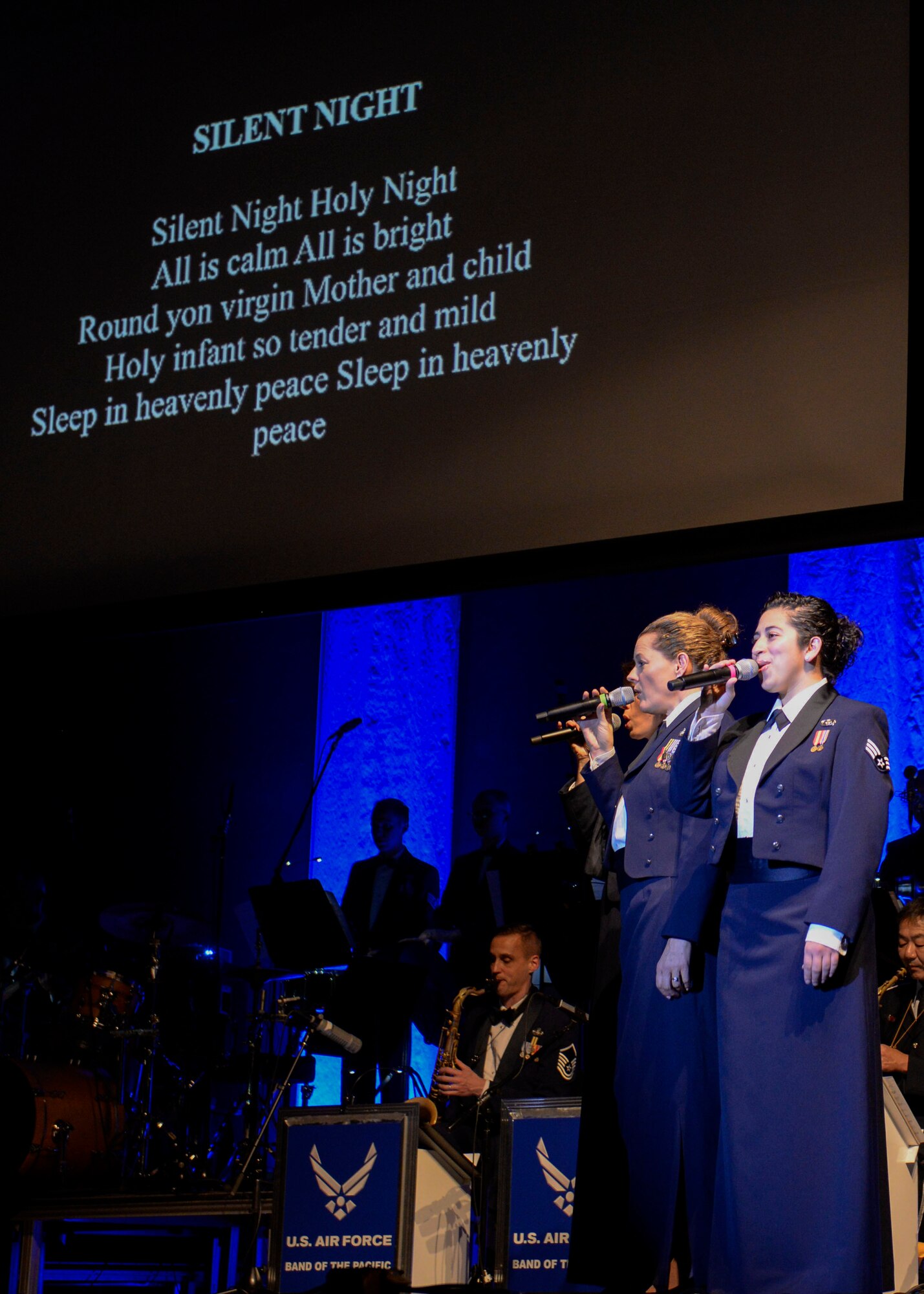 Vocalists from the U.S. Air Force Band of the Pacific lead a sing along during the Sounds of the Season concert, Dec. 19, 2017, at Yokota Air Base, Japan.