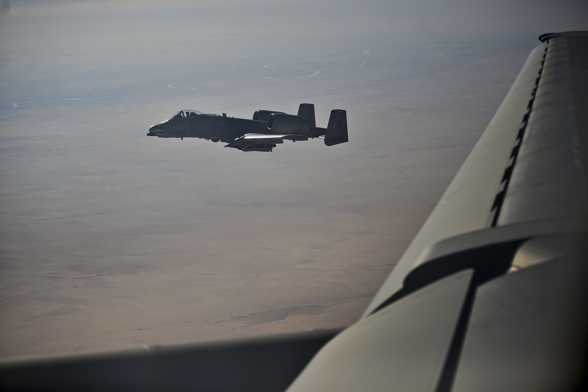 A U.S. Air Force A-10 Thunderbolt II pilot, currently assigned to the 332nd Air Expeditionary Wing, waits to be refueled by a KC-10 Extender over Iraq Dec. 2, 2017. The KC-10 can refuel a wide variety of U.S. and allied military aircraft within the same mission. 
 (U.S. Air Force photo by Tech. Sgt. Anthony Nelson Jr.)