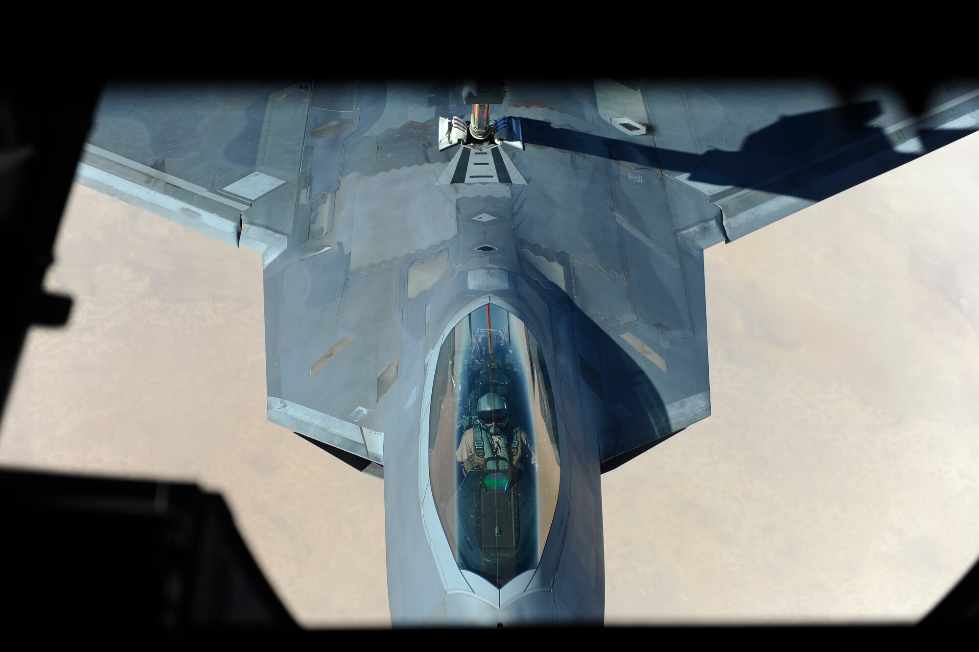 An F-22 pilot assigned to the 380th Air Expeditionary Wing, Al Dhafra Air Base, United Arab Emirates receives fuel over Iraq from a KC-10 Extender, Dec. 2, 2017.
 The F-22 is a component of the Global strike task force, supporting U.S. and Coalition forces working to liberate territory and people under the control of ISIS.

 (U.S. Air Force photo by Tech. Sgt. Anthony Nelson Jr.)