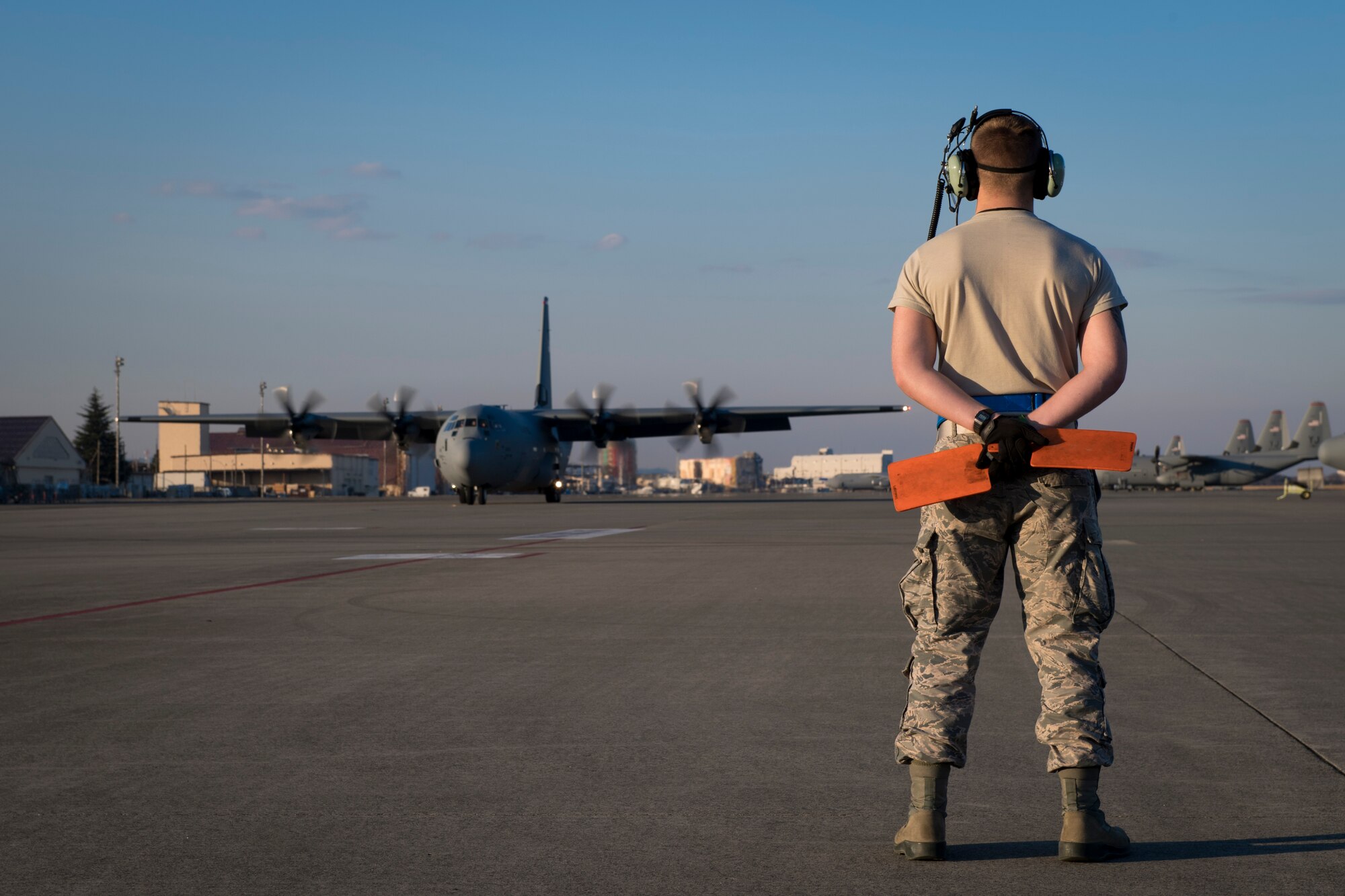 A 374th Maintenance Group Airman waits to marshal in a new C-130J Super Hercules, Dec. 21, 2017, at Yokota Air Base, Japan.
