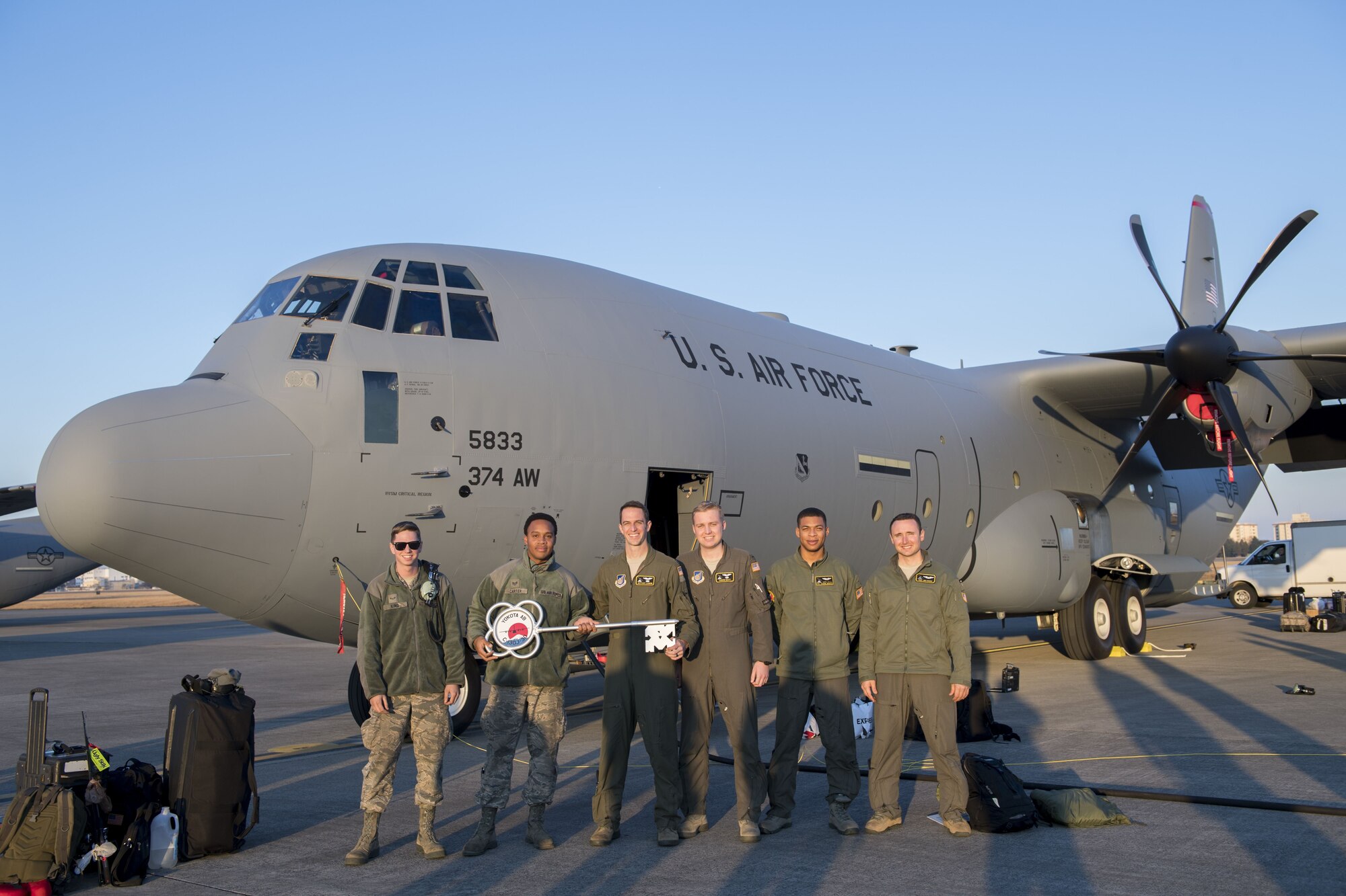 Members of the C-130J Super Hercules number 5833 delivery team pose for a photo, Dec. 21, 2017, at Yokota Air Base, Japan.