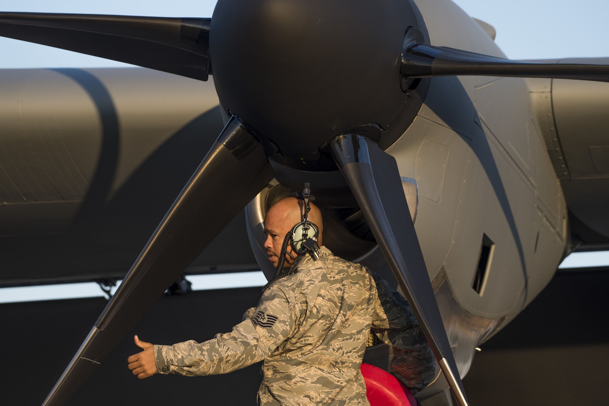 A 374th Maintenance Group Airman gives a thumbs up after inspecting a C-130J Super Hercules intake, Dec. 21, 2017, at Yokota Air Base, Japan.