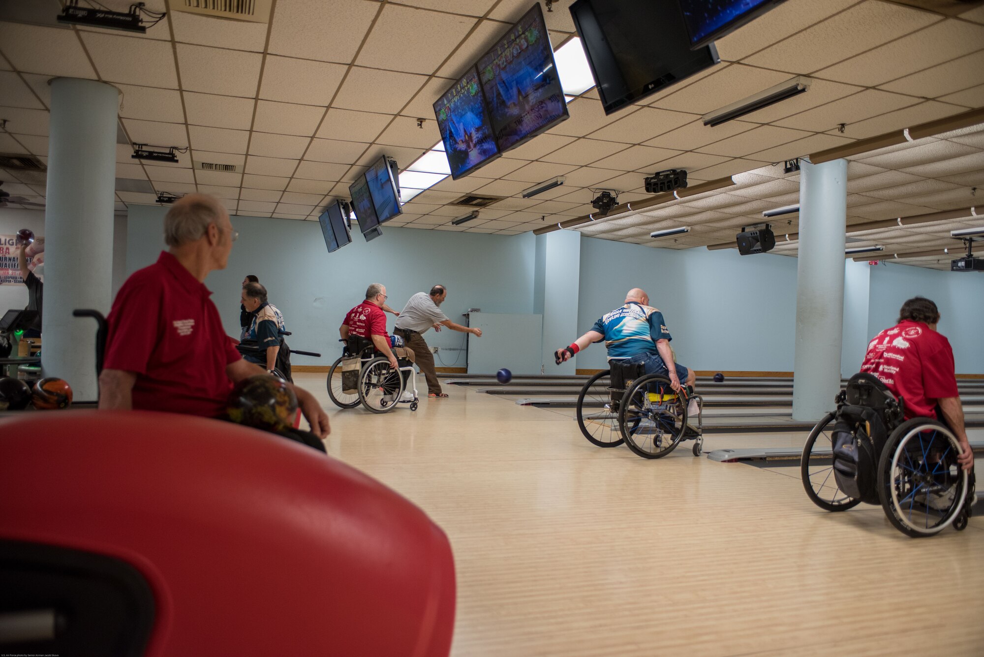 Wounded Warriors and disabled veterans bowl during an event hosted by the Office of the Warrior Advocate at Offutt Air Force Base, Nebraska, Dec. 21, 2017. The adaptive bowling event aimed to strengthen the community of injured active duty service members and veterans the office has been building since it was established in October 2016. (U.S. Air Force photo by Senior Airman Jacob Skovo)