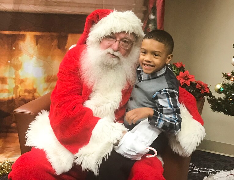 Malachi Abrahams, 6, sits with Santa during Selfies with Santa at Joint Base Langley-Eustis, Va., Dec. 8, 2017.
