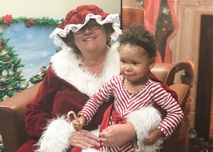 Carolina Brown, 4, sits with Mrs. Claus during Selfies with Santa at Joint Base Langley-Eustis, Va., Dec. 8, 2017.